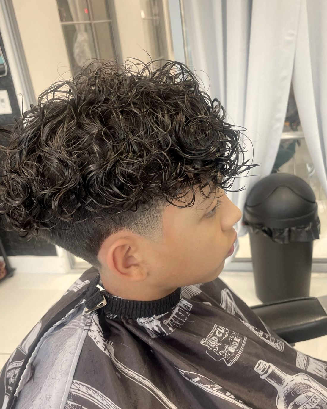 Curly top with a clean taper fade